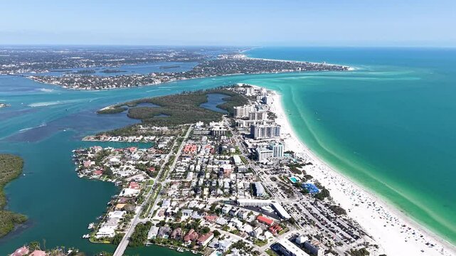 Beautiful aerial cinematic view of Sarasota, the magnificent white sand beach, and its iconic St. Armands Circle