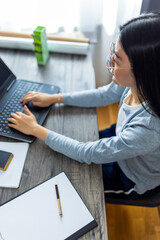 Young Thai Woman Working from Home on Computer