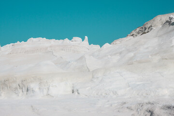 Stunning Sarakiniko Beach in Milos, Greece, showcasing its surreal white volcanic rocks under a clear blue sky.