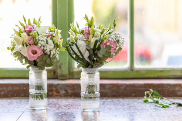 Wedding bouquets resting on windowsill with lisianthus and gypsophila