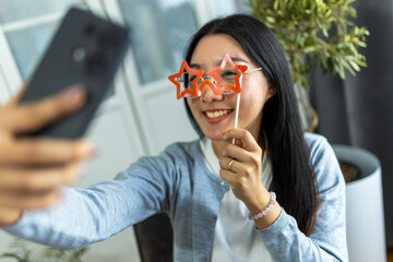 Young Thai Woman Taking a Selfie with Star-Shaped Glasses