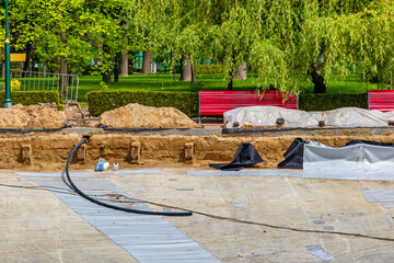 Reconstruction and repair of an artificial pond in a city garden or park. Construction of a large...