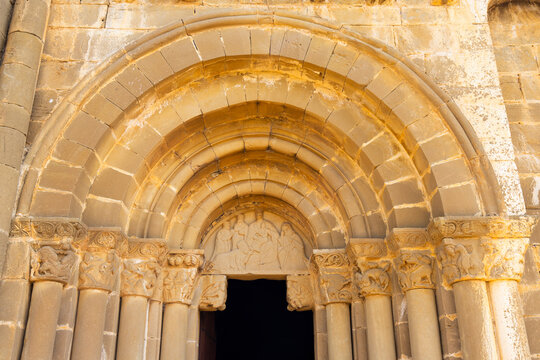 Romanesque archivolts decorating entrance of Santiago church in Aguero, Spain