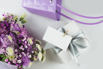 Bouquet of different purple flowers as a gift, white background. Gift for a holiday, Women's Day, Wedding, Mother's Day, March 8.