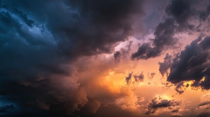 Fototapeta premium Dramatic sunset sky with dark storm clouds and vibrant orange hues