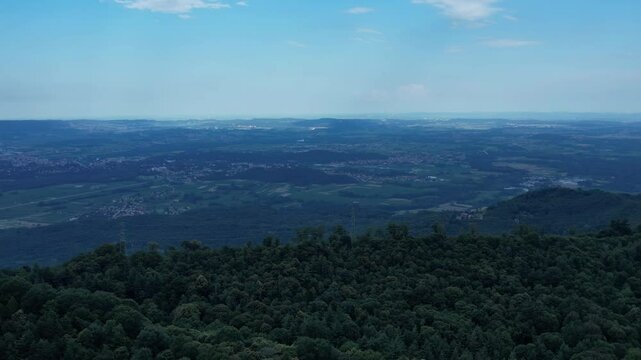 Aerial view of the Ivrea Morainic Amphitheatre, a vast glacial formation from the Pleistocene, with forests, farmland and villages near Ivrea, Italy, drone shot, slow motion