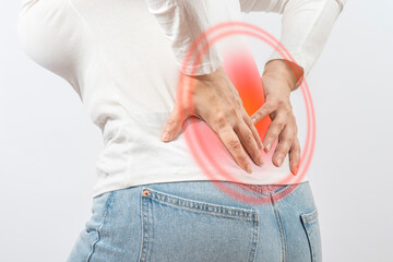 Woman grabbed his lower back. Radiculitis symptom, inflammation, pain in the spine