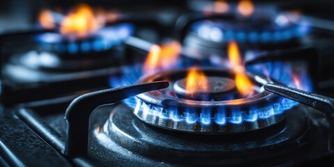 A High Resolution image of modern gas stove burner with intense flames. Close-up view of a hot glowing gas burner. Energy and heat from a cooking appliance. Details of a kitchen hob.