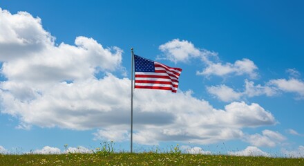 American flag waving in a field under a partly cloudy sky