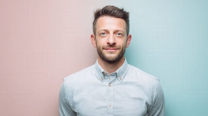 Confident Young Man Smiling Against a Soft Color Background