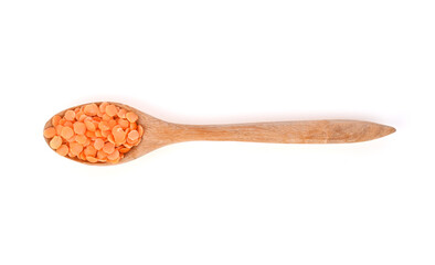 red lentils and wood spoon isolated on white background top view