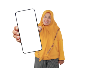 Muslim woman in yellow hijab smiling and holding blank screen smartphone toward the camera