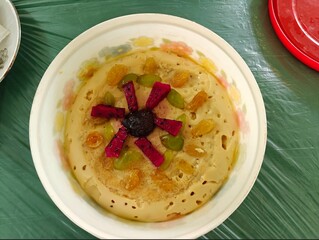 Homemade sweet dish with beautiful decoration of fruit slices on the top.