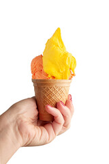 
Strawberry and mango flavored ice cream served in a wafer basket and a female hand holding it. Photographed on a neutral background