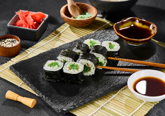 Hosomaki roll with chuka seaweed, high-contrast lighting, minimalist composition