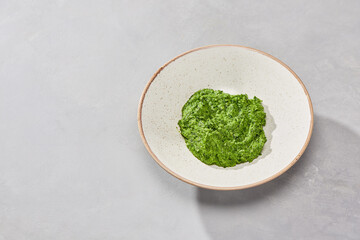Creamed spinach in minimalist presentation, soft natural lighting, bright color palette