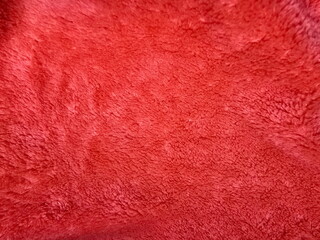 Dark orange fabric background. Flannel fabric is a warp knit fabric structure with ruffled pile on both sides. Flannel imitation fur texture.Used to clothes, plaids, blankets, bed sheets and pajamas.
