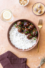 Beef meatballs in teriyaki sauce with rice. Asian food.