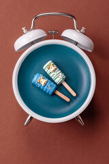 Christmas, eclair on a plate on a vintage clock. Christmas time conceptual background