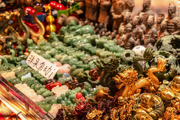 Fototapeta premium Souvenirs. Explore unique jade and gold figurines in a vibrant Shanghai market filled with treasures