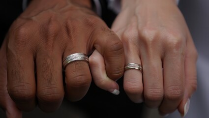 Interracial couple joining hands with wedding rings signifying unity and love Celebrating interracial marriage National Loving Day