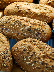 Freshly baked multigrain bread loaves cooling on a rack in a warm kitchen