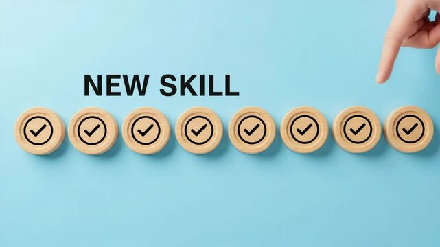 Hand selecting a wooden coin with a check mark on a blue background illustrating new skills aquisition