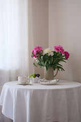 A Beautiful and Elegant Table Setting Featuring Fresh Flowers and Tea for a Perfect Gathering