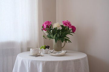 A Beautiful and Elegant Table Setting Featuring Fresh Flowers and Tea for a Perfect Gathering