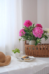 Charming Floral Arrangement with a Stylish Hat and Delicious Treats for Home Display