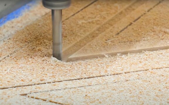 CNC machine cutting wood in workshop precision manufacturing process closeup