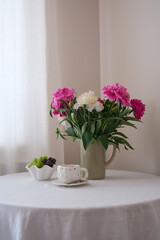 A Beautiful and Elegant Table Setting Featuring Fresh Flowers and Tea for a Perfect Gathering