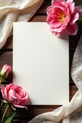 Blank notecard on wooden surface; delicate floral accents, flowing fabric, simple, clean