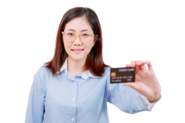 Asian young beautiful woman in glasses and a striped shirt holds a credit card towards the camera, smiling slightly.