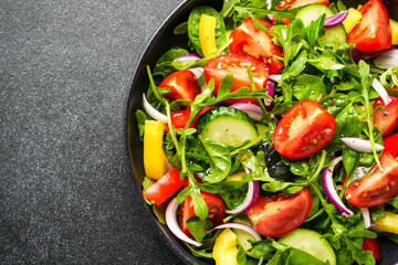 Salad with leaves, tomatoes, pepper and olive oil.