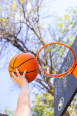 Basketball player shooting the ball towards the hoop