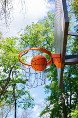 A basketball hoop with a ball in the air