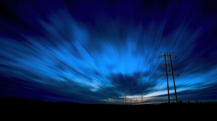 Obraz premium Glowing power lines against a deep blue sky, abstract energy infrastructure with dramatic contrast lighting, symbolizing modern urban vitality.