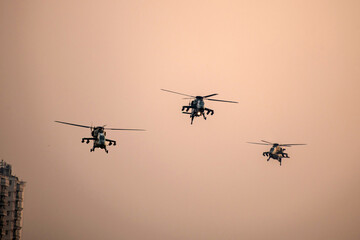 Military helicopter air attack by a squadron during dawn