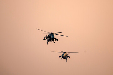 Military helicopter air attack by a squadron during dawn