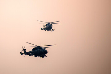 Military helicopter air attack by a squadron during dawn
