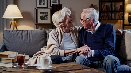 Elderly couple share laugh and affection. Long relationship built on years of love and joy. Close bond of love grows in warm home. Relationship filled with shared affection and lasting love