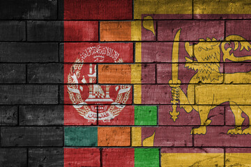 colourful painted big national flag of afghanistan and flag of sri lanka on a massive old brick wall background. concept