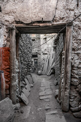 An arch in the stone wall on the narrow street of the ancient tibetan village Kagbeni in Mustang, Nepal.
