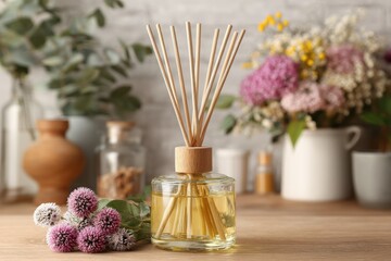 Aromatic reed diffuser with essential oils, flowers, and vases creates a cozy ambiance and fresh fragrance for home and spa environments, promoting relaxation and well-being.
