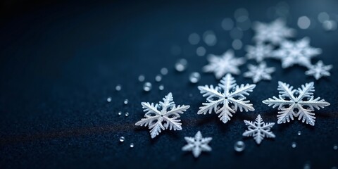 A macro shot of snowflakes on a dark wool surface