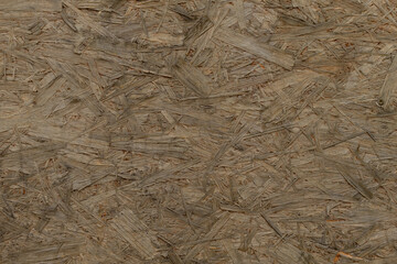 This image showcases oriented strand board, which is a type of wood panel made from compressed strands of wood, and is widely utilized in construction, as well as in furniture manufacturing