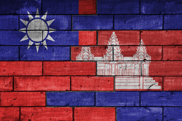 colourful painted big national flag of taiwan and flag of cambodia on a massive old brick wall background. concept