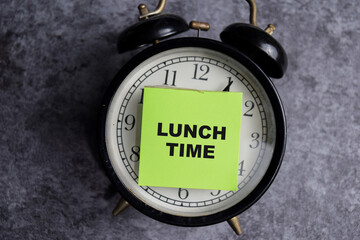 Concept of Lunch time write on sticky notes isolated on Wooden Table.