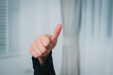 Business hand gesture success signal modern workspace indoor office environment close-up view